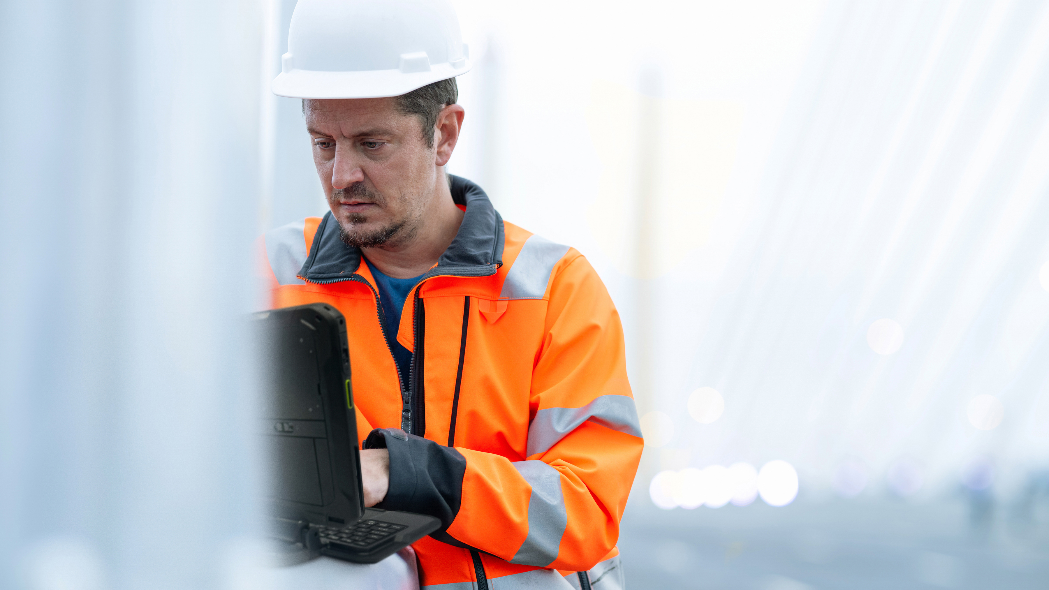 A field operations engineer using a rugged tablet.