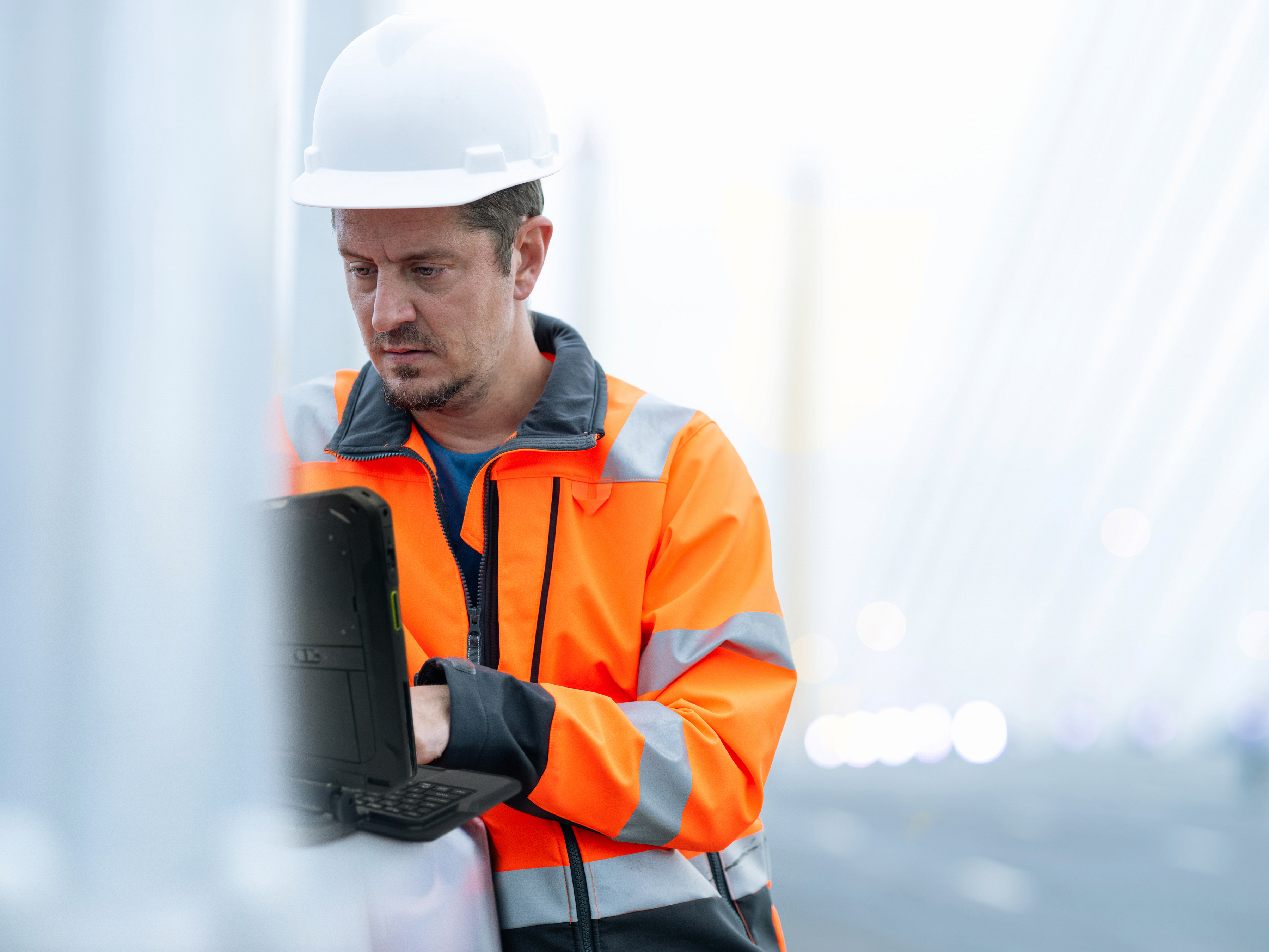 A field operations engineer using a rugged tablet.