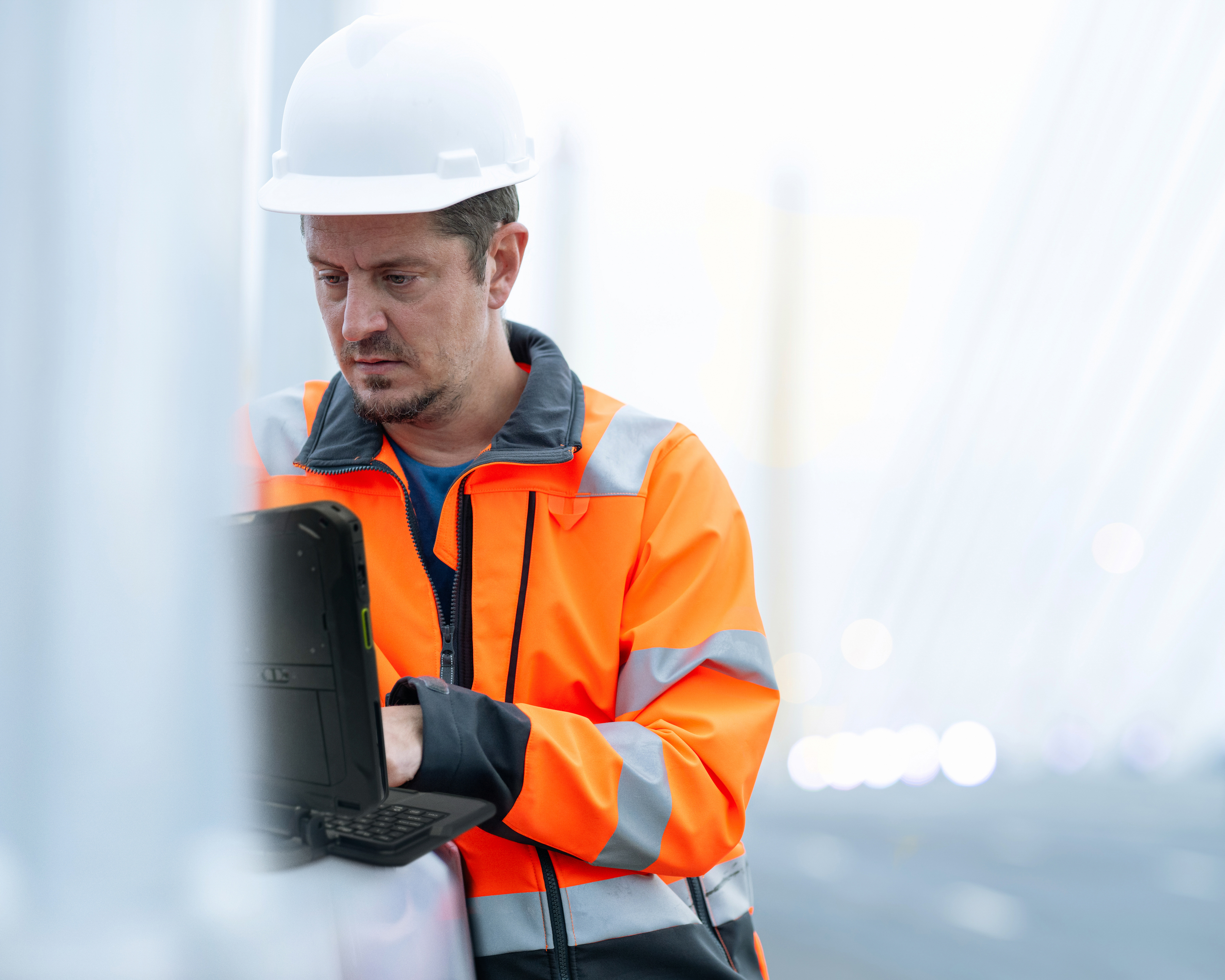 A field operations engineer using a rugged tablet.