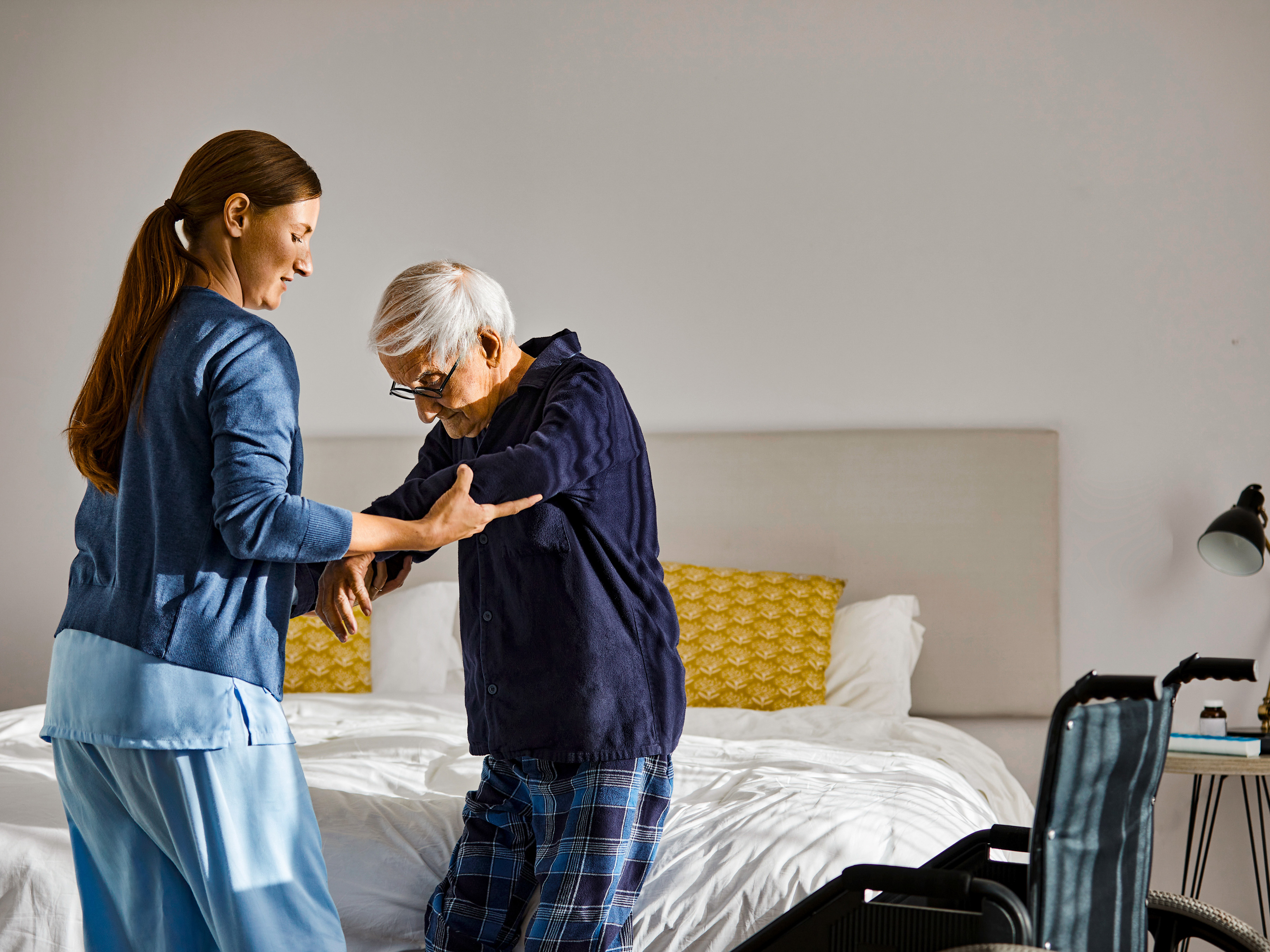 Medical professional assisting a patient at home.