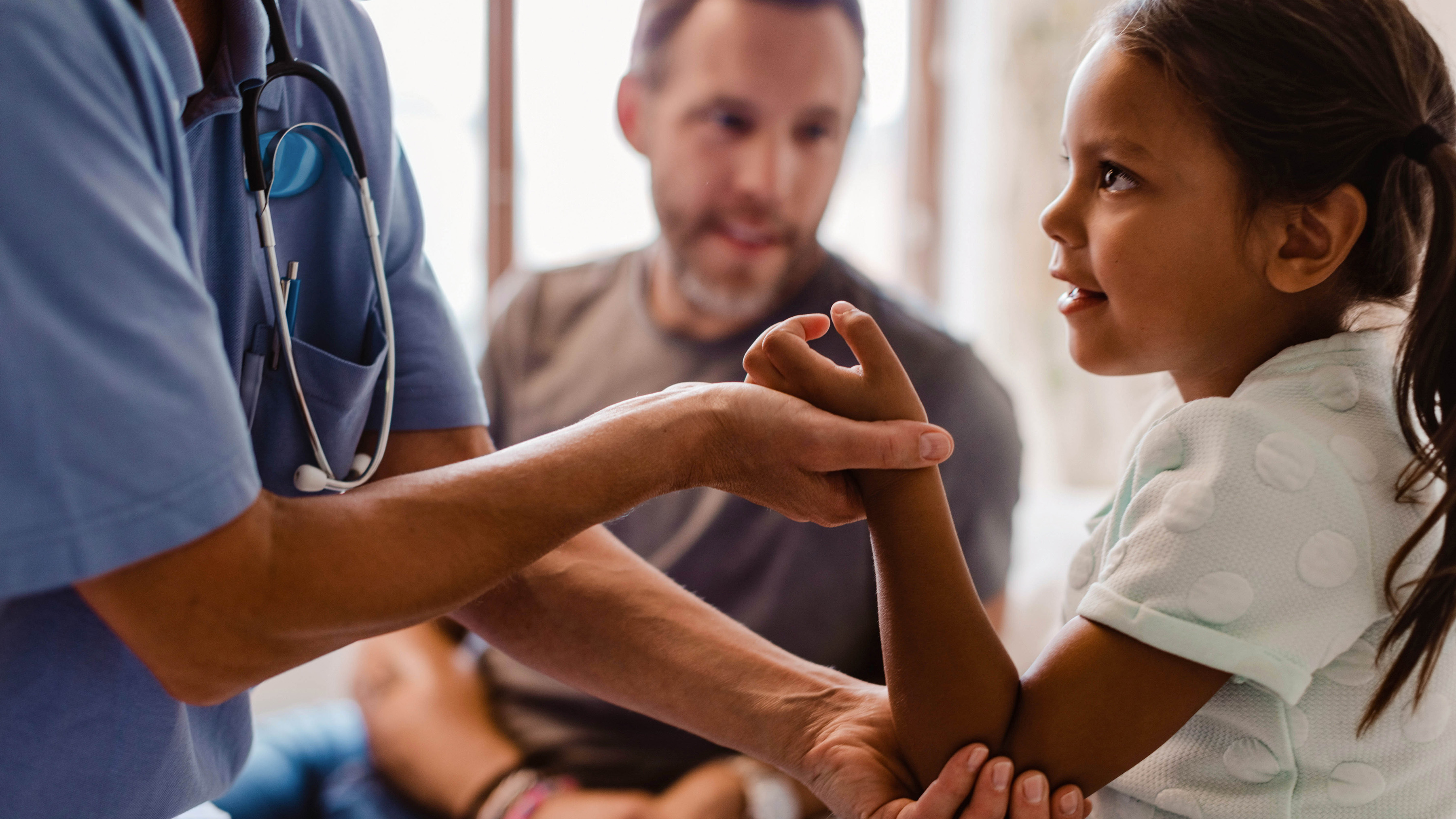 A child patient getting checked by a medical professional.