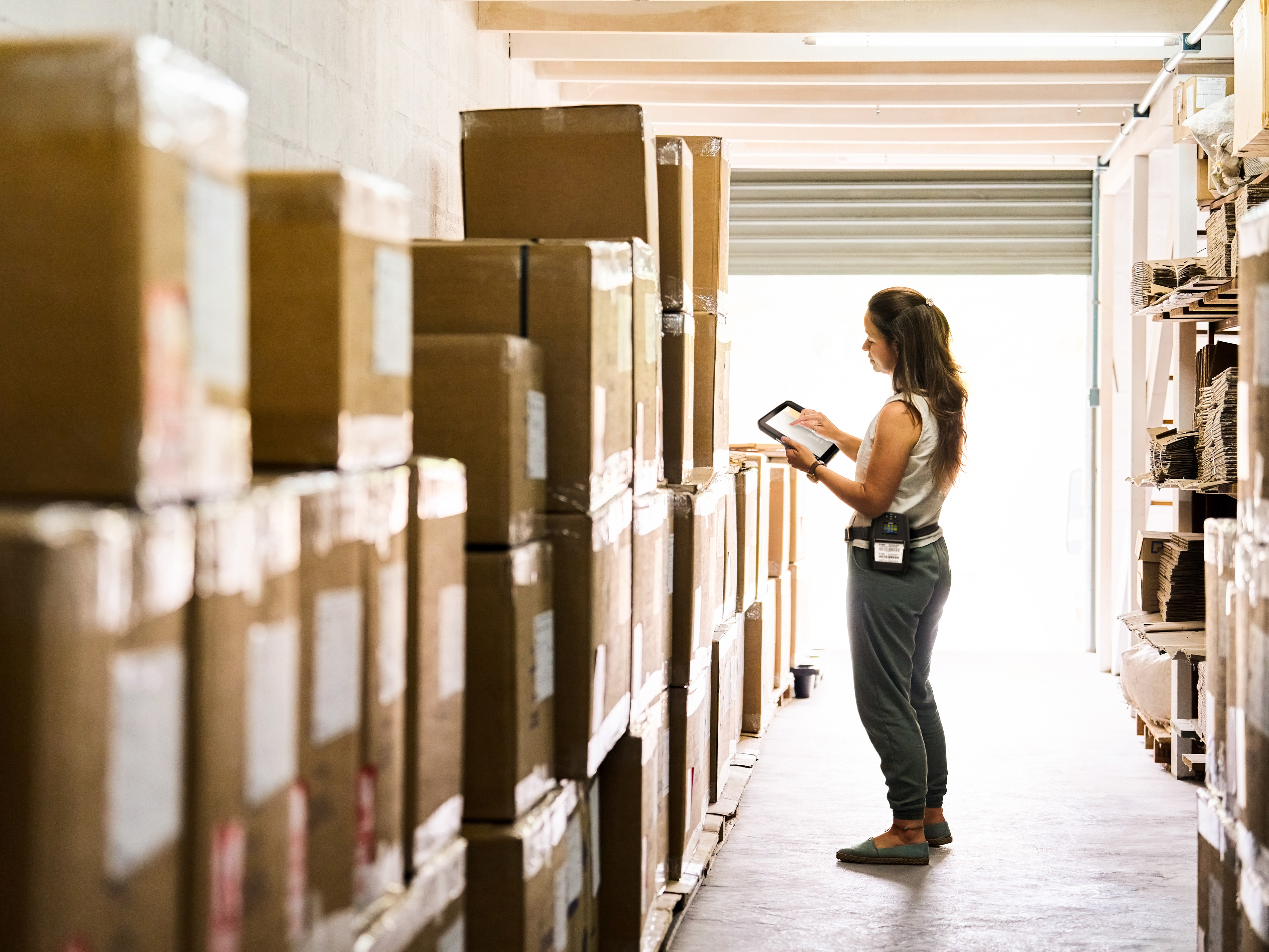 An employee handling box deliveries using a Zebra tablet.