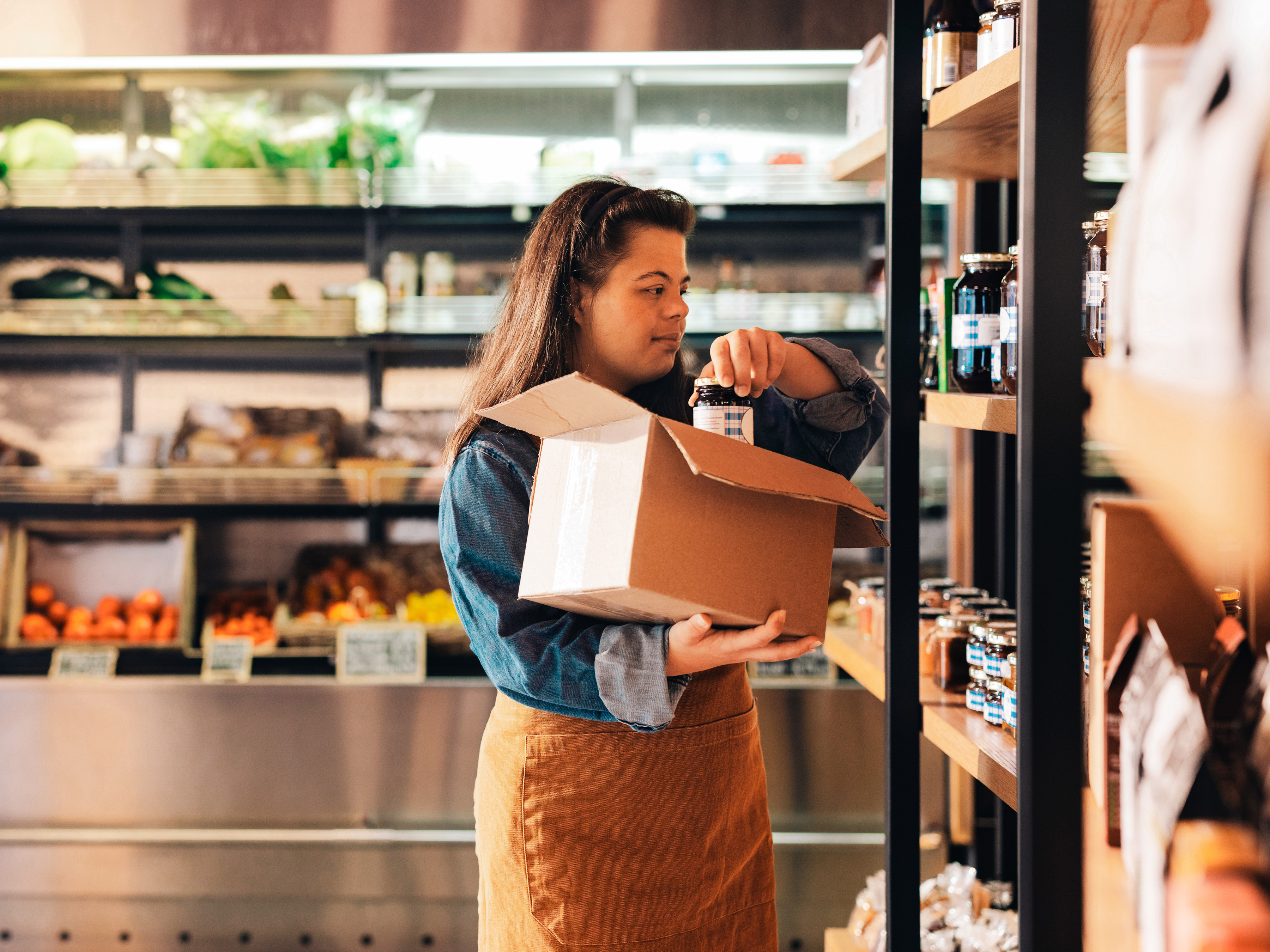Employee restocking in a grocery store.