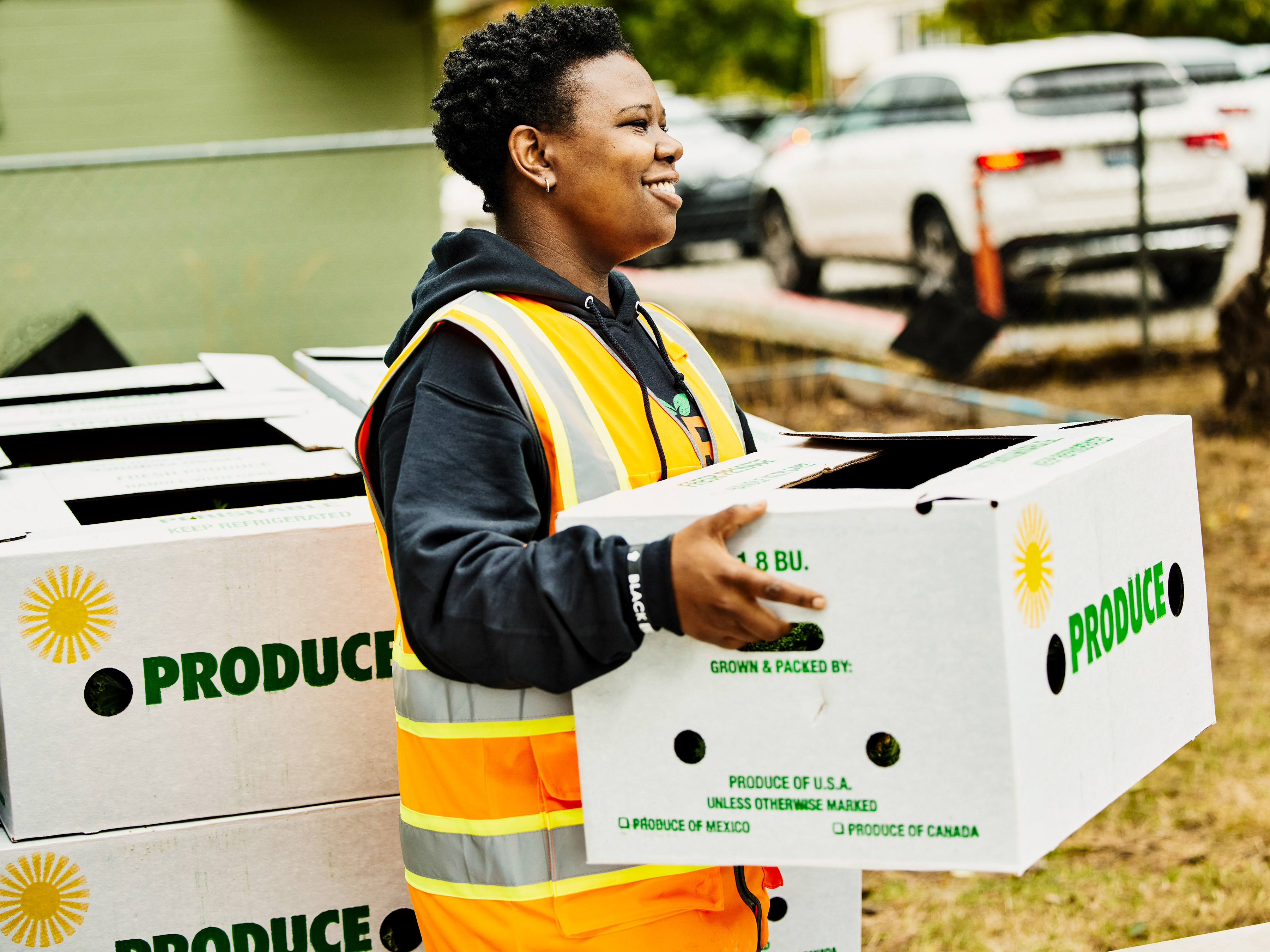 Volunteer delivering produce to a community center.