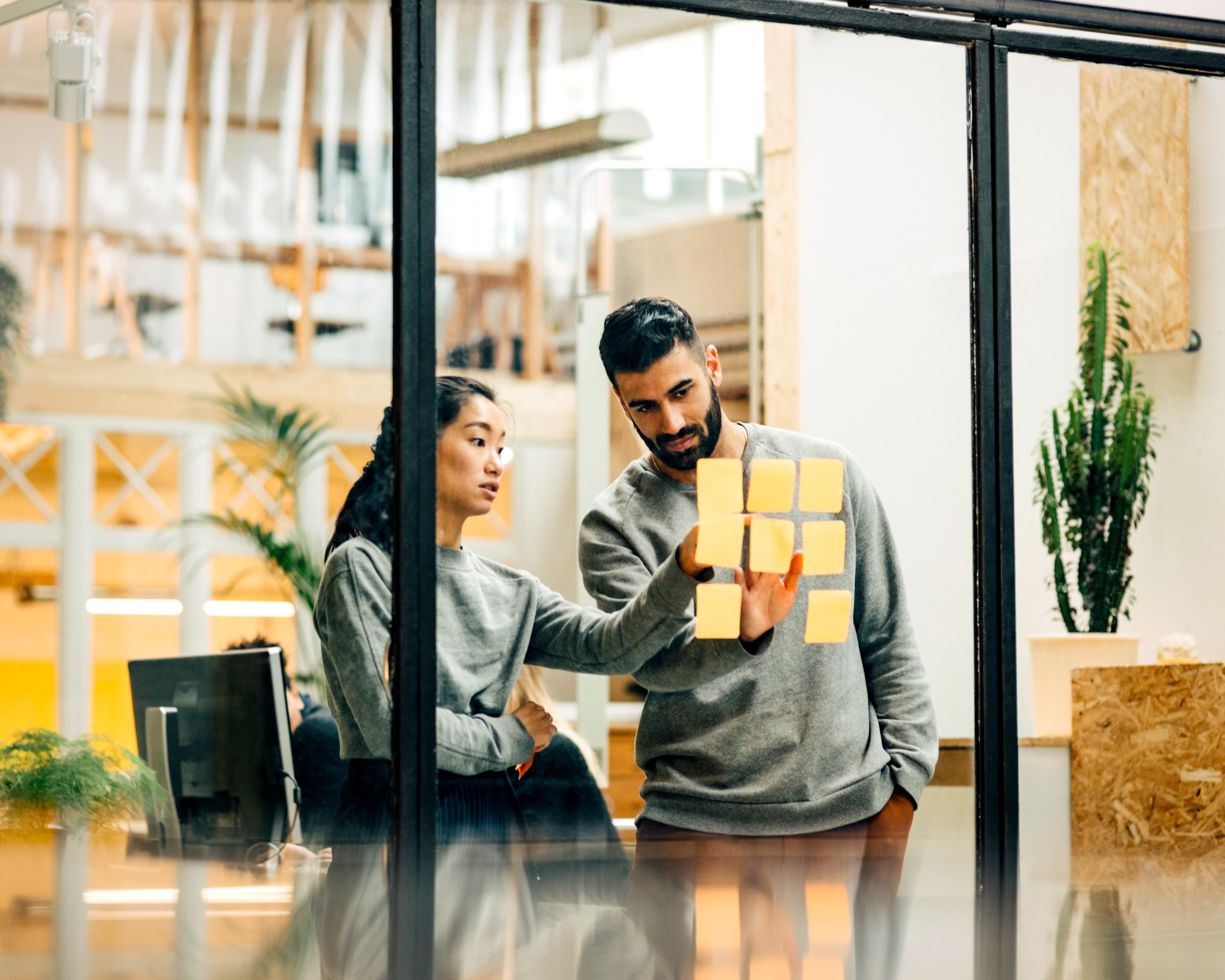 Coworkers brainstorming business ideas in an open office space