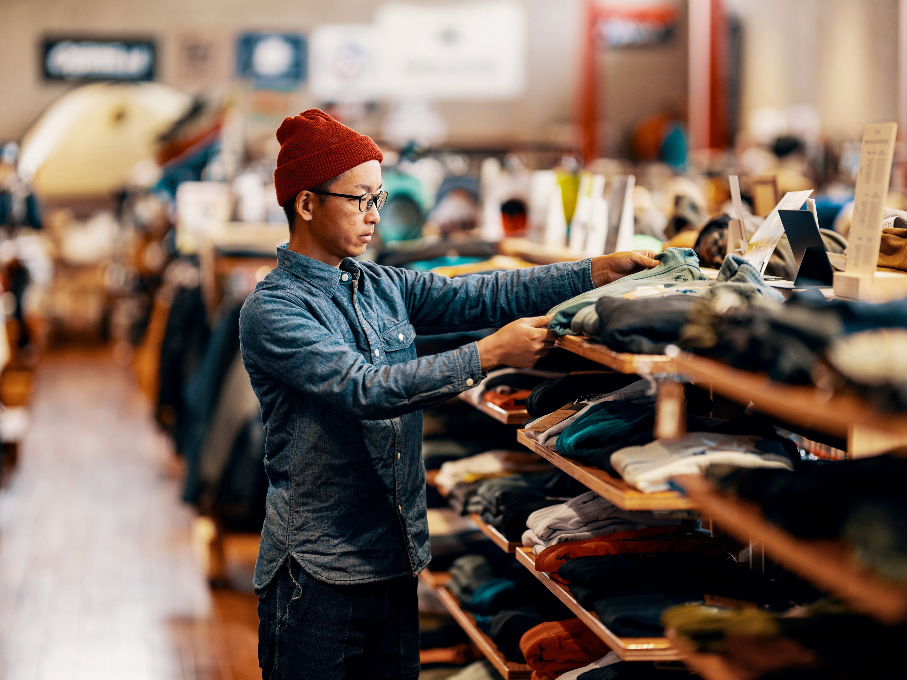 Employee folding clothing in a retail store. 