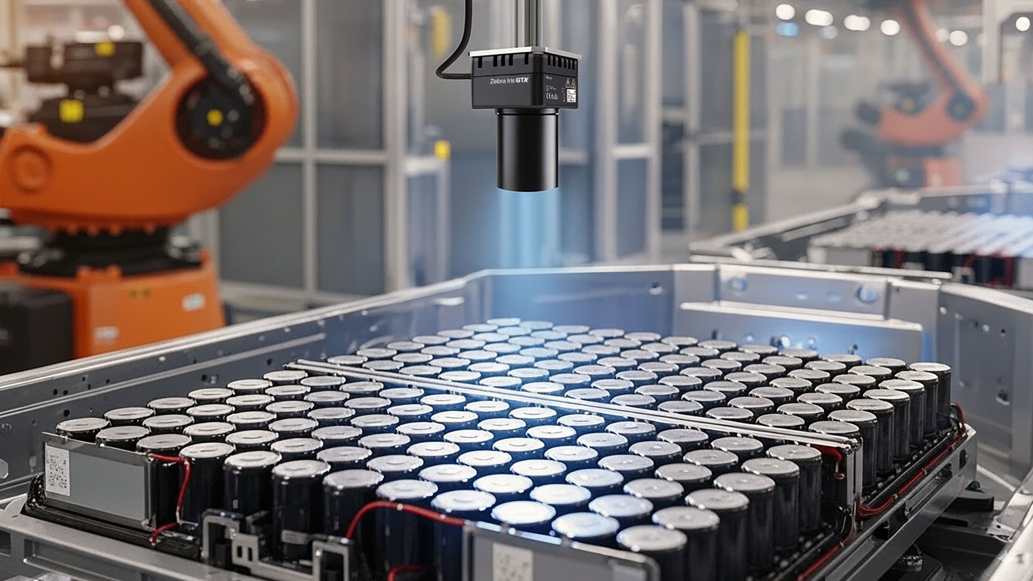 Automated manufacturing warehouse with a close up view of a Iris GTX camera inspecting an electric vehicle battery