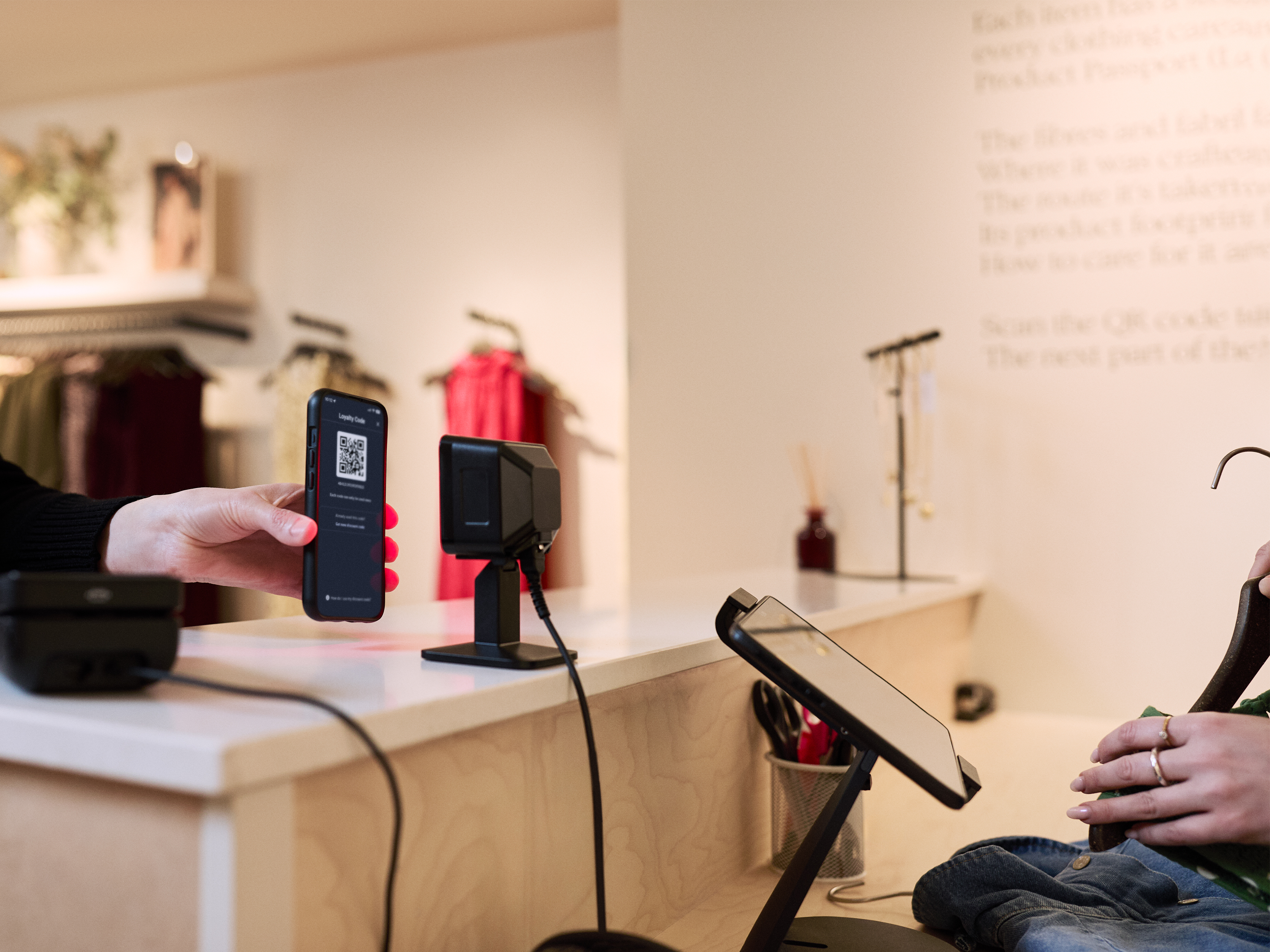 SP20 on counter scanner taking  QR code from a mobile device during a retail sale transaction.