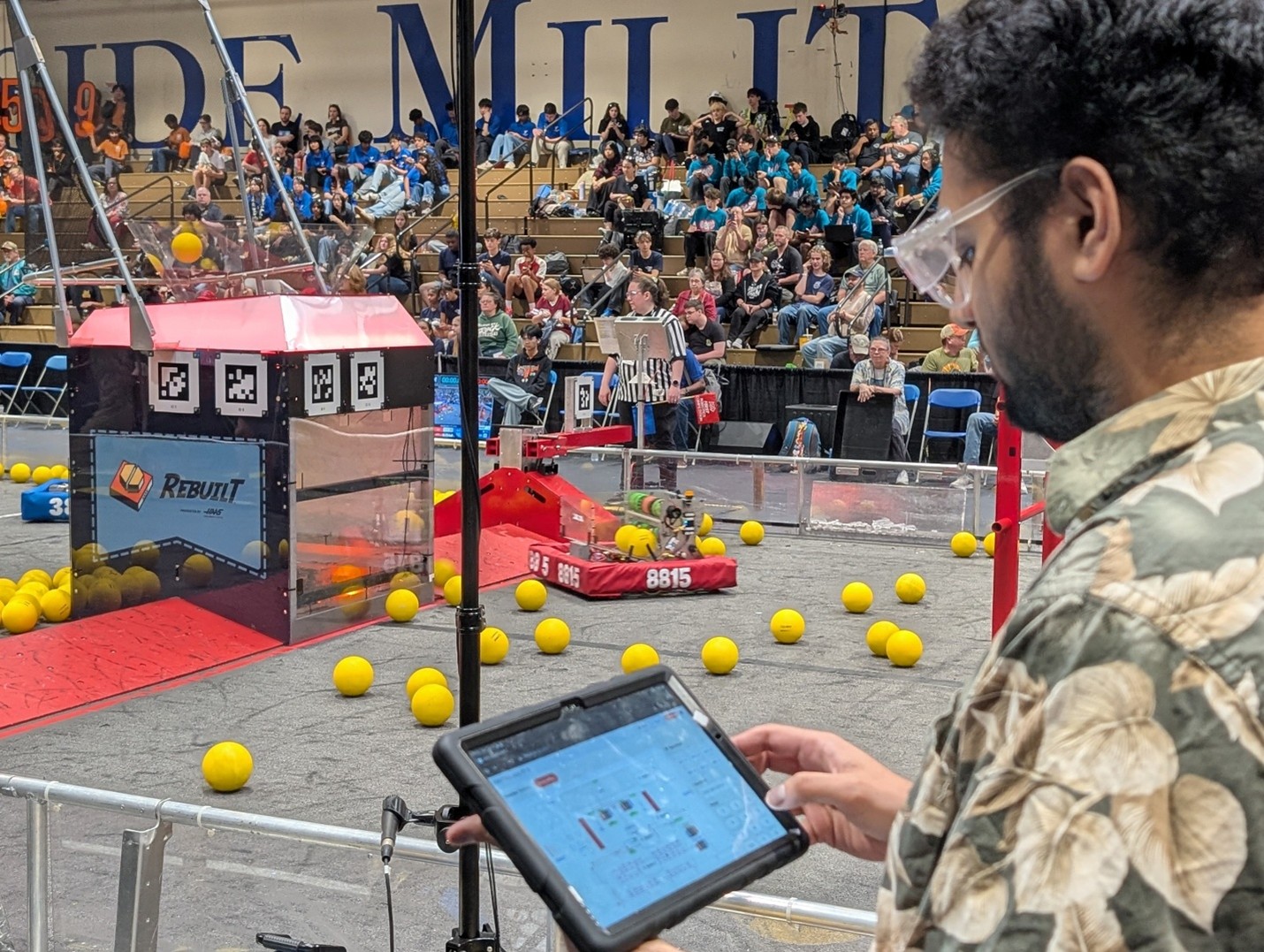Robotics operator using tablet in a robotics competition.