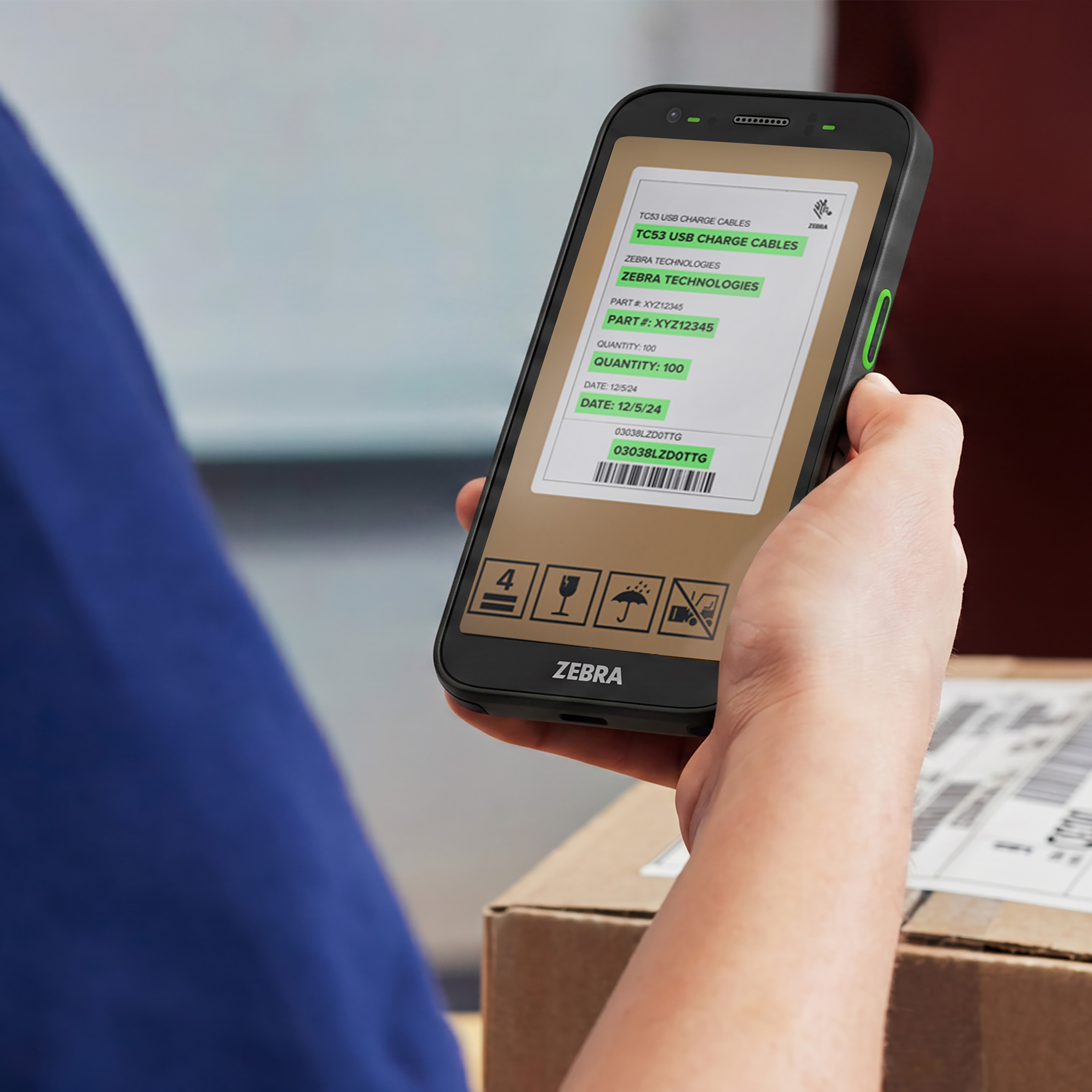 Photo of a postal worker using a TC501 to scan a UPC on a box. 