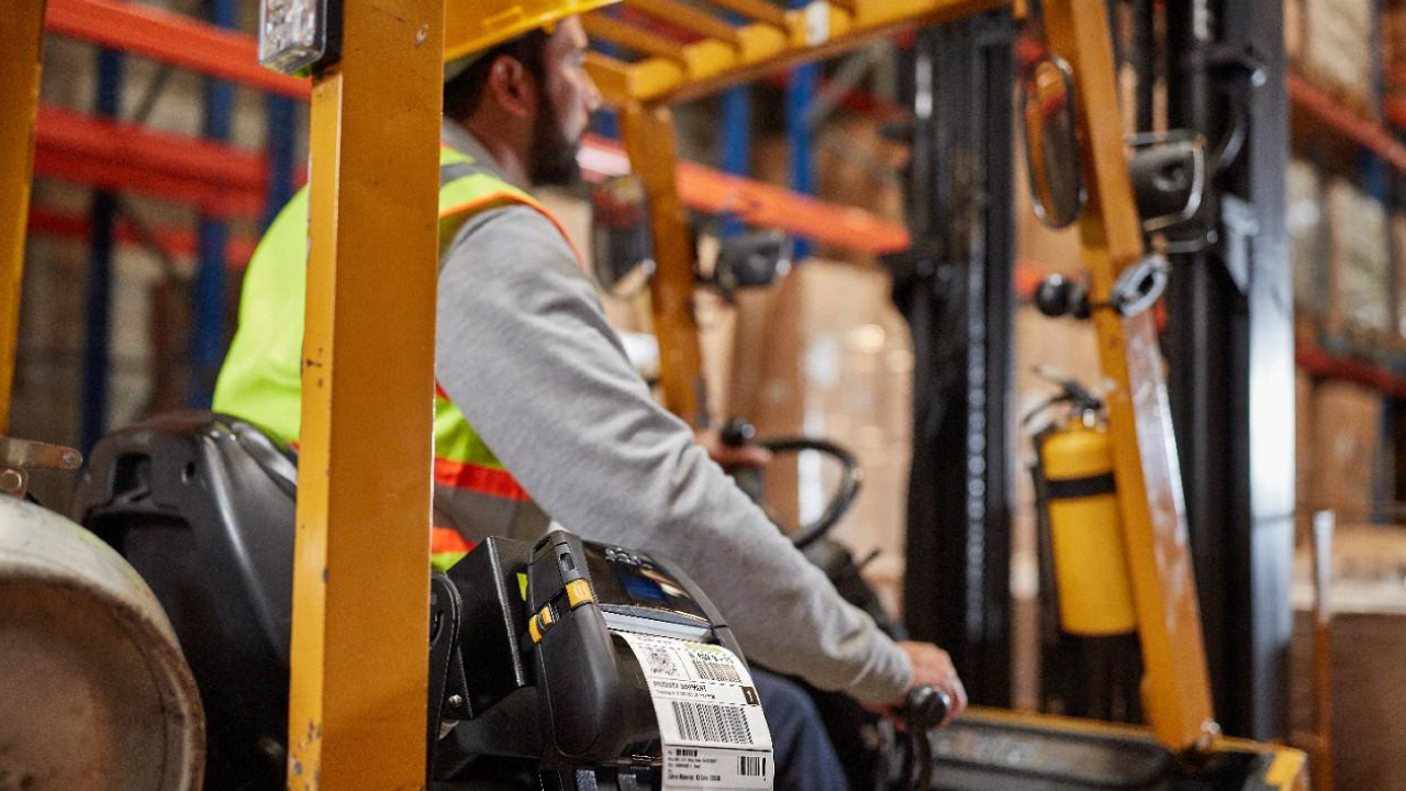 A forklift operator navigates a warehouse