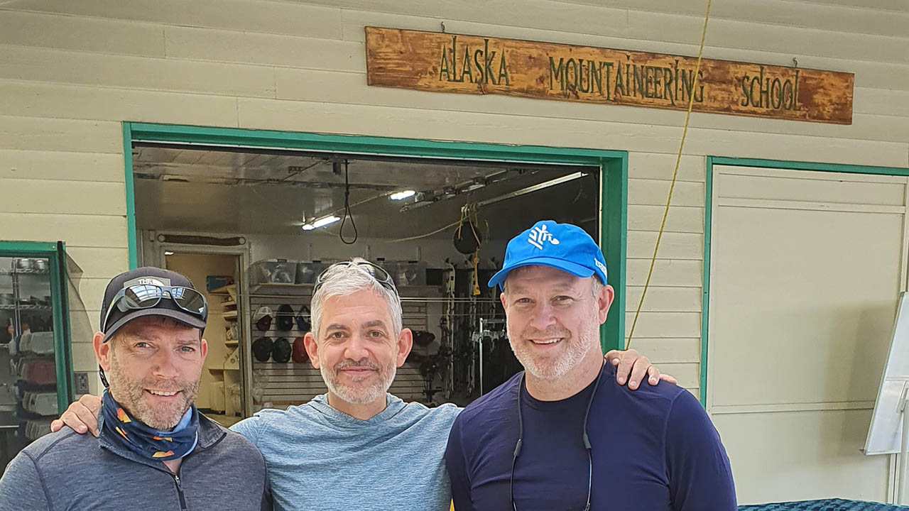 Mark Thomson, Simon Wallis and Jason Harvey - the Three Amigos from Zebra - standing in front of a shop in Alaska before heading to Denali