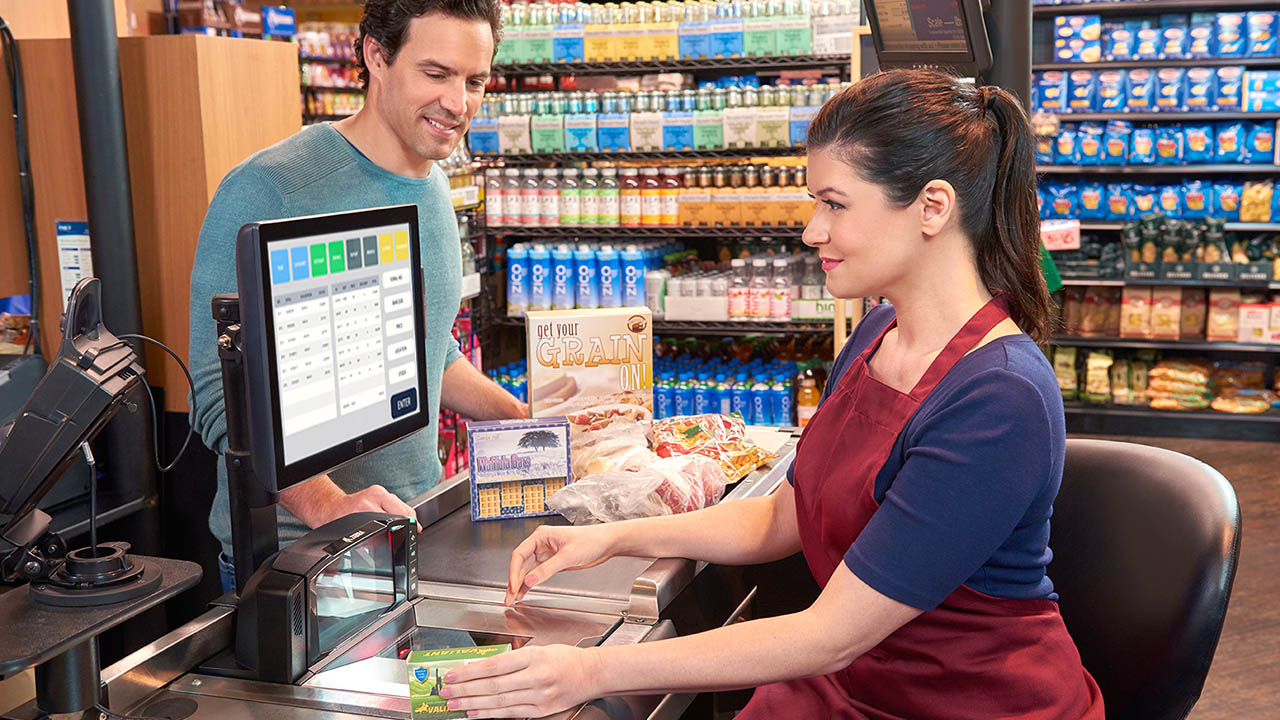 A grocery associate uses a Zebra MP7000 scanner at the point of sale