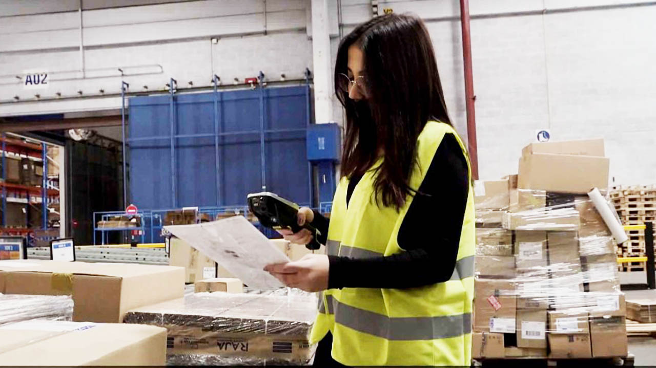 A warehouse worker scans an item