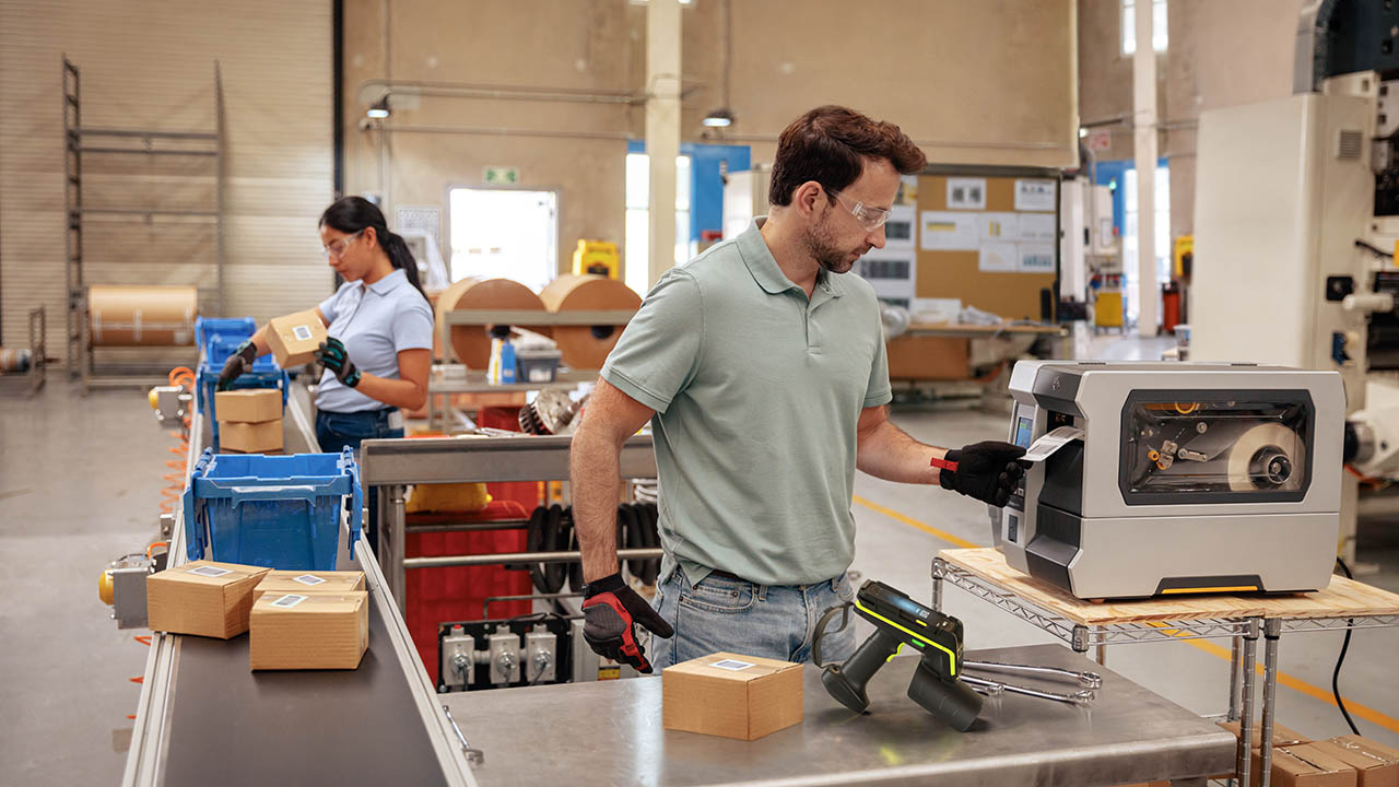Manufacturing plant workers add RFID tags to outbound goods and verify readability